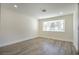 Bright bedroom with wood-look floors and a large window at 3180 S Tioga Way, Las Vegas, NV 89117