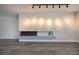 Modern linear fireplace with gray mantel and wood-look flooring at 3180 S Tioga Way, Las Vegas, NV 89117