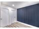 Clean hallway with modern blue accent wall and doors at 3180 S Tioga Way, Las Vegas, NV 89117