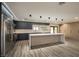 Modern kitchen with dark cabinetry, island, and marble countertops at 3180 S Tioga Way, Las Vegas, NV 89117