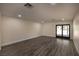 Bright living room with gray walls and wood-look floors at 3180 S Tioga Way, Las Vegas, NV 89117