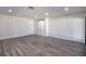 Spacious living room with wood-look floors and barn door at 3180 S Tioga Way, Las Vegas, NV 89117