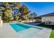 Inviting rectangular pool with light colored coping and decking at 3180 S Tioga Way, Las Vegas, NV 89117