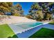 Refreshing swimming pool, surrounded by artificial turf at 3180 S Tioga Way, Las Vegas, NV 89117