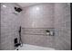 Spa-like shower with gray tile and built-in shelving at 3180 S Tioga Way, Las Vegas, NV 89117