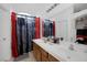 Double vanity bathroom with shower and red curtains at 3309 Jamaica Princess Pl # 3, North Las Vegas, NV 89084