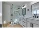 Modern bathroom with marble shower, double vanity, and black fixtures at 3367 Vema Dr, Las Vegas, NV 89121