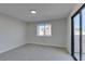 Spacious bedroom with window, carpet flooring, and access to balcony at 3367 Vema Dr, Las Vegas, NV 89121