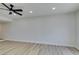 Open living room with light walls and wood-look flooring at 3367 Vema Dr, Las Vegas, NV 89121