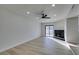 Living room with light walls, laminate floors, fireplace, and sliding glass door at 3367 Vema Dr, Las Vegas, NV 89121