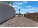 Gravel backyard with partial fence and palm tree at 3446 Cactus Springs Dr, Las Vegas, NV 89115