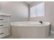 Bathroom with corner soaking tub, vanity, and shower at 3446 Cactus Springs Dr, Las Vegas, NV 89115