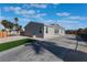 Single-story home with gray siding, a long driveway, and a landscaped yard at 3446 Cactus Springs Dr, Las Vegas, NV 89115