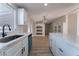 Modern kitchen features white cabinets, quartz countertops, and a stainless steel sink at 3446 Cactus Springs Dr, Las Vegas, NV 89115