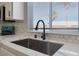 Sleek kitchen sink with a modern black faucet and hexagonal tile backsplash at 3446 Cactus Springs Dr, Las Vegas, NV 89115