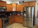 Modern kitchen with stainless steel appliances and wood cabinets at 3925 Vulcan St, Las Vegas, NV 89122