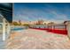 Large backyard with a pool and red deck at 402 Bell Ave, Henderson, NV 89015