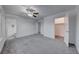 Bright bedroom with gray carpet, ceiling fan, and ensuite bathroom at 402 Bell Ave, Henderson, NV 89015