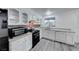 Renovated kitchen, featuring white cabinets and gray flooring at 402 Bell Ave, Henderson, NV 89015