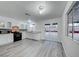 Bright kitchen with white cabinets, modern appliances, and gray flooring at 402 Bell Ave, Henderson, NV 89015