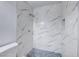 Clean shower with marble-look tile and blue-tiled floor at 402 Bell Ave, Henderson, NV 89015