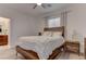 Bright bedroom with wood bed frame and white bedding at 4138 Bayley Skye Ave, Las Vegas, NV 89141