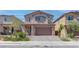 Two-story home with attached garage and landscaped front yard at 4138 Bayley Skye Ave, Las Vegas, NV 89141