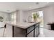 Modern kitchen island with white countertop and sink at 4138 Bayley Skye Ave, Las Vegas, NV 89141