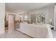 Bright living room with white couch, decorative mirrors, and a view into the dining area at 4138 Bayley Skye Ave, Las Vegas, NV 89141