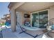 Covered patio with comfortable seating and a hammock at 4138 Bayley Skye Ave, Las Vegas, NV 89141