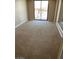 Bright bedroom featuring wall-to-wall carpeting and sliding glass doors at 431 Bedford Rd, Las Vegas, NV 89107