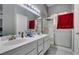 Double sink bathroom with walk-in shower and red towels at 4421 Rodman Dr, Las Vegas, NV 89130