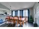 Bright dining room with a table, seating for eight, hardwood floors, and large windows at 4421 Rodman Dr, Las Vegas, NV 89130