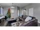 Spacious living room with dark leather sectional sofa and a Christmas tree at 4421 Rodman Dr, Las Vegas, NV 89130