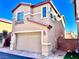 Two-story house with tan exterior, red roof accents, and a garage at 4520 Lemon Gems Ct, Las Vegas, NV 89130