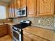 Kitchen with wood cabinets and granite countertops at 4520 Lemon Gems Ct, Las Vegas, NV 89130