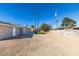 Artificial turf backyard with a view of the home's exterior and palm trees at 4962 E Baltimore Ave, Las Vegas, NV 89104