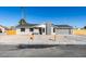 Remodeled single story home with gray exterior and wood fence at 4962 E Baltimore Ave, Las Vegas, NV 89104