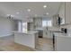 Bright kitchen boasts an island, white quartz countertops, and gray cabinets at 4962 E Baltimore Ave, Las Vegas, NV 89104