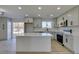 Modern kitchen with island, stainless steel appliances, and light gray cabinets at 4962 E Baltimore Ave, Las Vegas, NV 89104