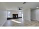 Bright living room features hardwood floors, fireplace, and ceiling fan at 4962 E Baltimore Ave, Las Vegas, NV 89104