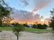 View of a golf course and sunset from the backyard at 5381 Waving Sage Dr, Las Vegas, NV 89149