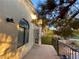 Balcony featuring tile flooring, iron railing, and views of the mature trees and garden at 5381 Waving Sage Dr, Las Vegas, NV 89149