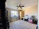 Bedroom with carpet, ceiling fan, and built-in shelving at 5381 Waving Sage Dr, Las Vegas, NV 89149