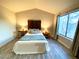 Well-lit bedroom featuring hardwood floors and a large window with sheer curtains at 5381 Waving Sage Dr, Las Vegas, NV 89149