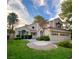 Two-story house with tile roof, landscaping, and a three-car garage at 5381 Waving Sage Dr, Las Vegas, NV 89149