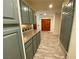 Hallway with gray cabinets and wood flooring at 5381 Waving Sage Dr, Las Vegas, NV 89149