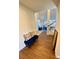 Hallway with hardwood flooring, a blue bench, and a glimpse of the living area at 5381 Waving Sage Dr, Las Vegas, NV 89149