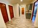 Long hallway with wood flooring and access to rooms at 5381 Waving Sage Dr, Las Vegas, NV 89149