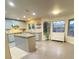 Modern kitchen with island, light gray cabinets, concrete countertops, and stainless steel appliances at 5381 Waving Sage Dr, Las Vegas, NV 89149